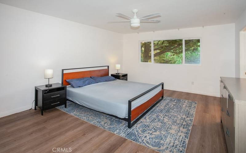 The primary suite is enriched by a large picture windows, lighted ceiling fan ample closet space to maximize storage and gleaming wood laminate floors.