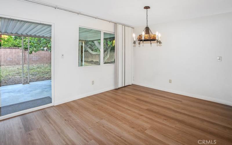 The formal dining room is conveniently located off the kitchen, and with its sparkling window, drop down lighting and wood laminate floors, it is perfect for any occasion.