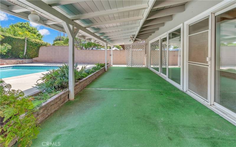 Long covered patio near the pool side.