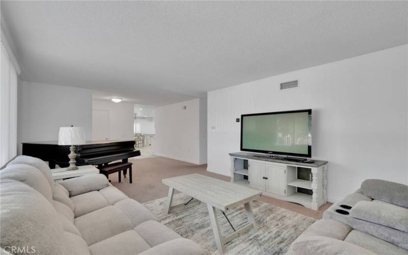 Open floor plan leading to kitchen to the left and bedrooms to the right