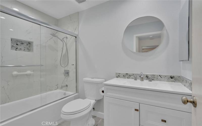 Remodeled Hallway bathroom with tub in shower