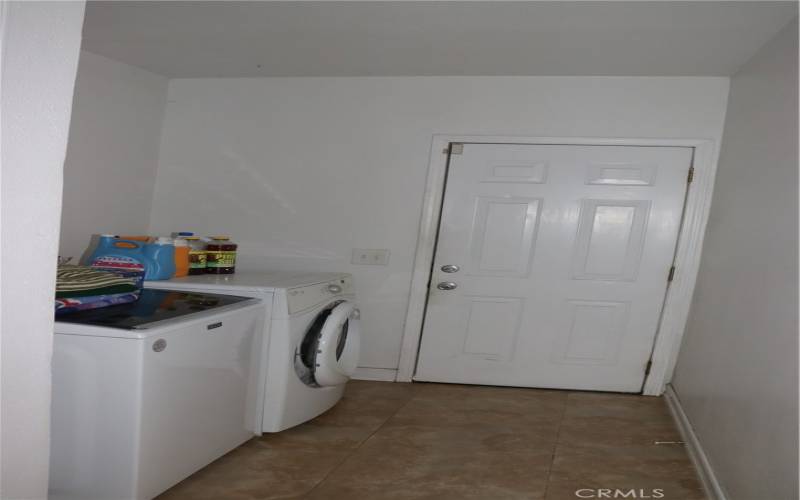 laundry room off of kitchen, next to back door going into backyard