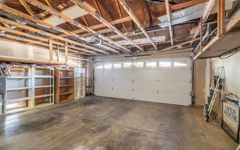 2 car enclosed garage with extra shelves for storage