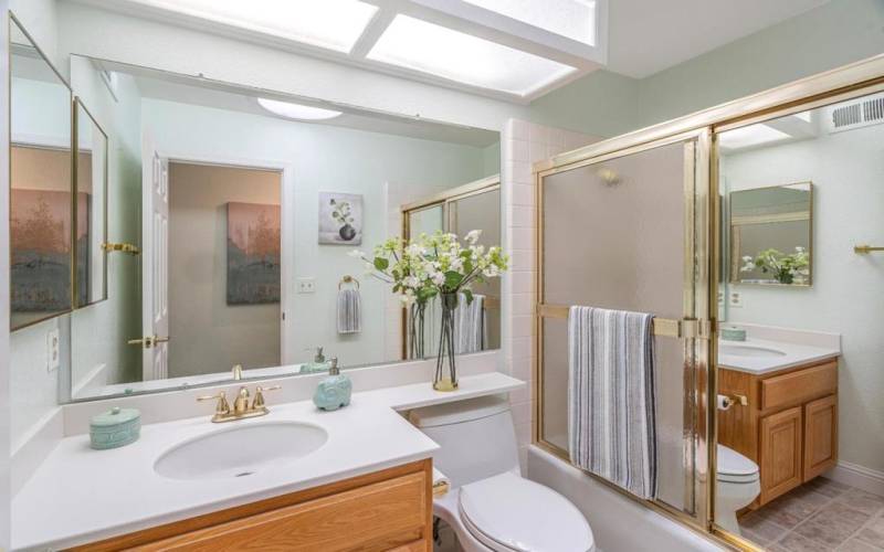 second bathroom located on the right of the hallway with a soaking tub & bright ceiling skylight