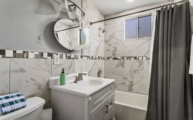 Hall bathroom with shower and tub