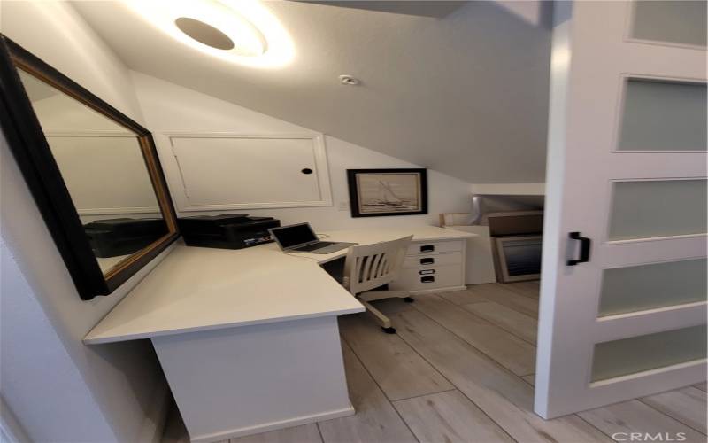 Small office area located under stairway can be used as storage as well