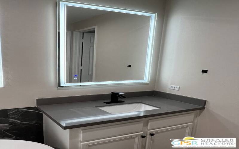 En Suite Vanity with lit mirror