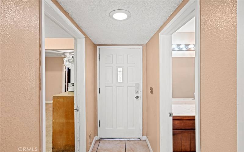 Left of entry door goes into the converted garage/usable space.  right of the door is 1/2 bath to service the downstairs.