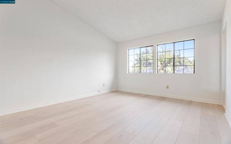 Primary bedroom with Vaulted Ceiling