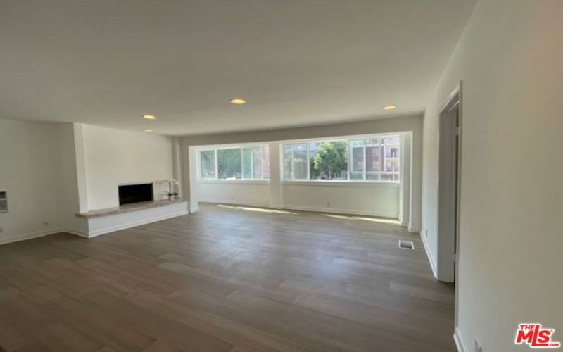 Oversized den facing the street with fireplace