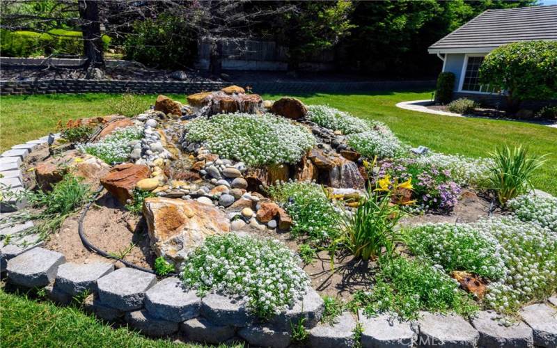 Water fall with flowers in front yard