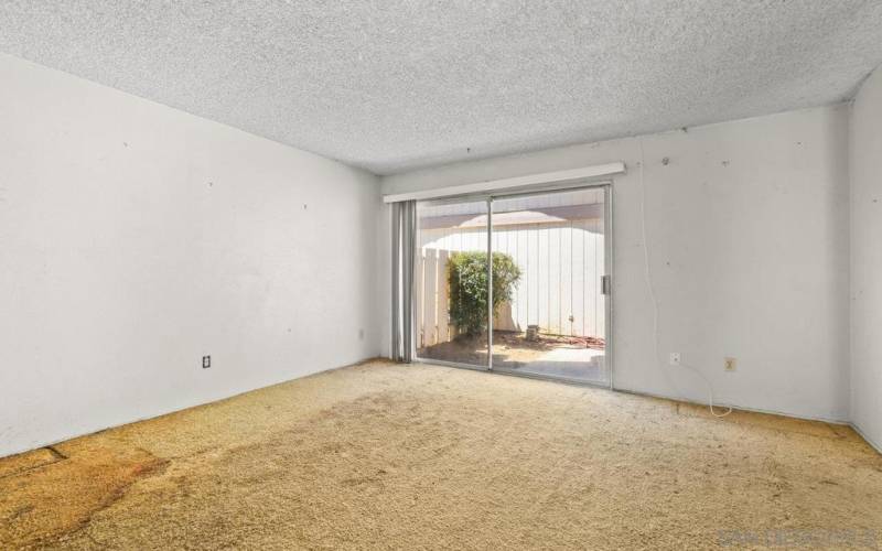 Living room with sliding glass door to front courtyard