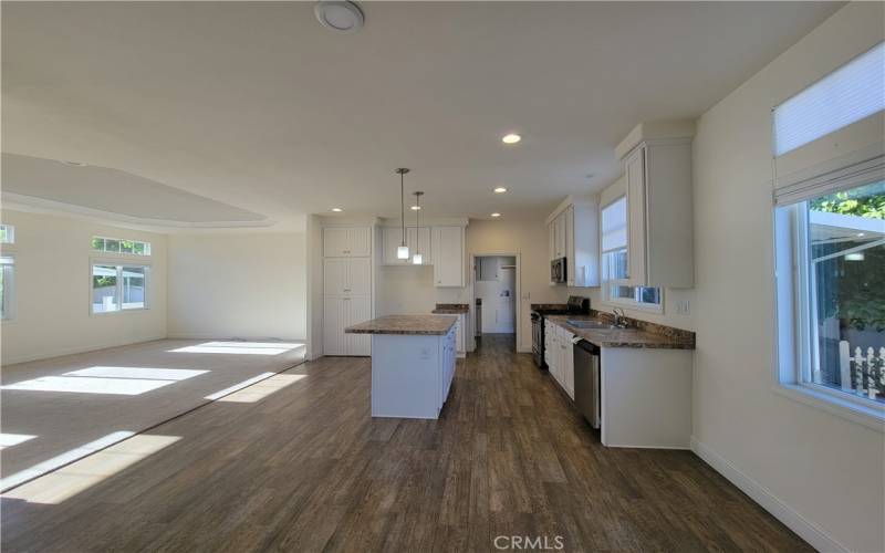 View of the kitchen and living room from the arched entry to the office.