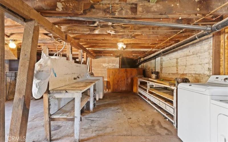 basement work shop area with tables and shelves