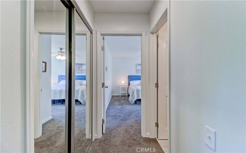 HALLWAY WITH MIRRORED DOOR CLOSETS