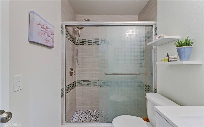 TILED SHOWER WITH SLIDING GLASS DOORS