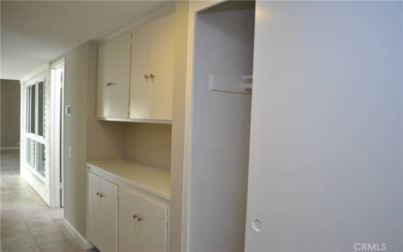 Hallway storage cabinets and closet.