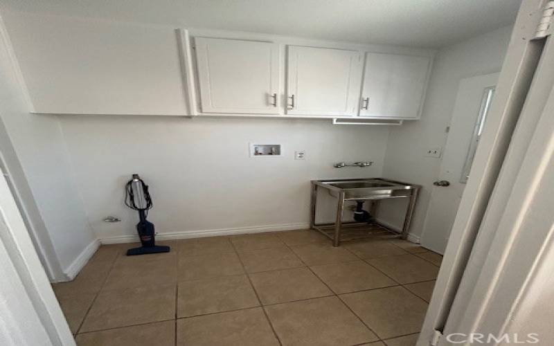 Utility room with sink that connects to the kitchen with washer and dryer hook-ups ...