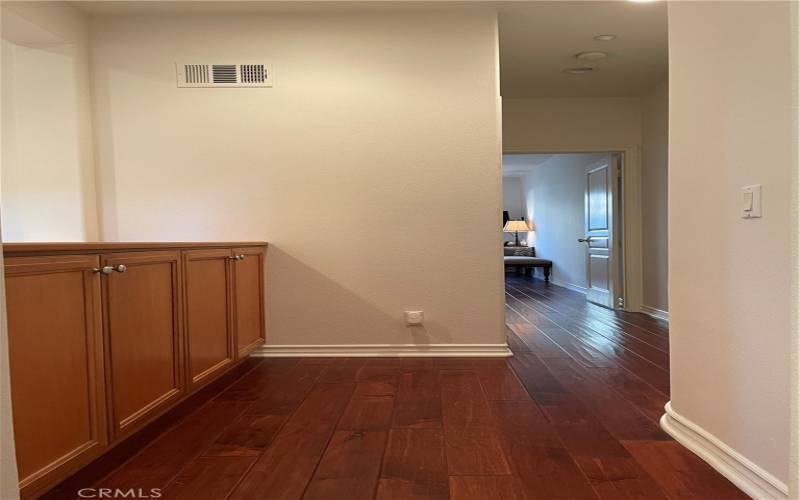 Hallway to guest bedroom with built-in cabinet for extra linen storage