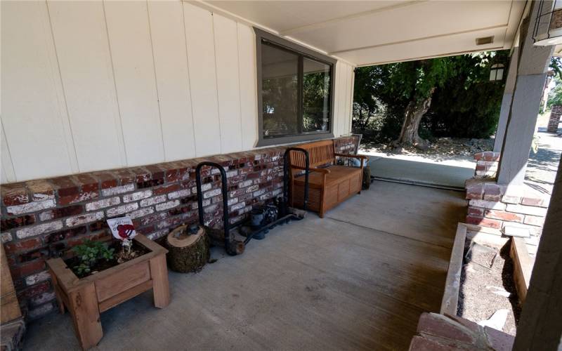 Porch has planters and brick columns