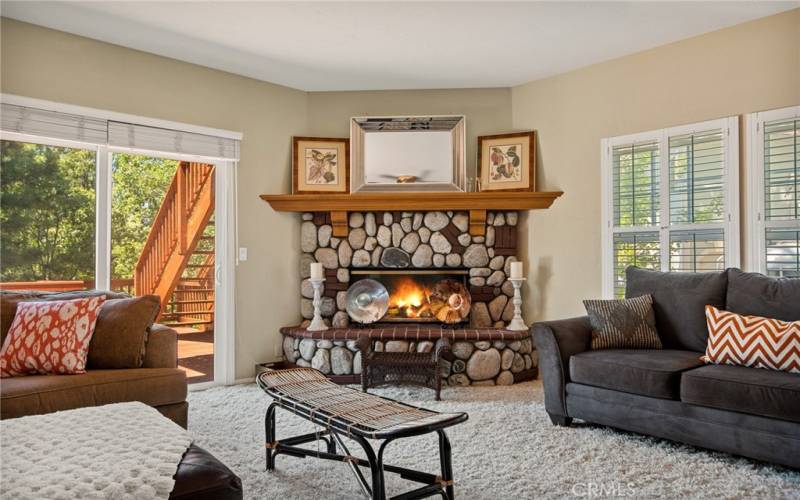 Stone Fireplace in Den with Sliding door to large deck and the views.