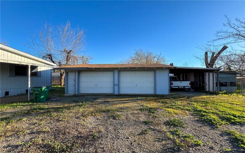 large 2 car garage + carport & coop