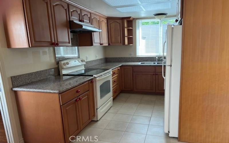 Updated kitchen with granite counters and wood cabinets