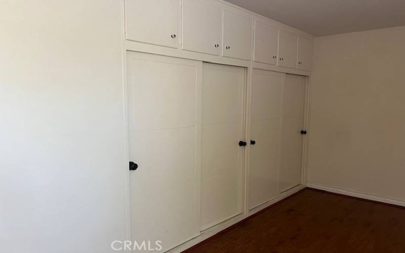 The primary bedroom features a large closet with deep cabinet storage above.