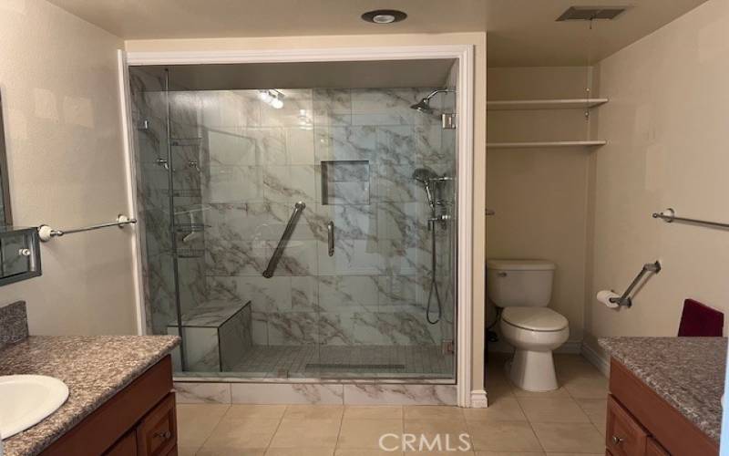 Remodeled bathroom with nice step in shower with bench.