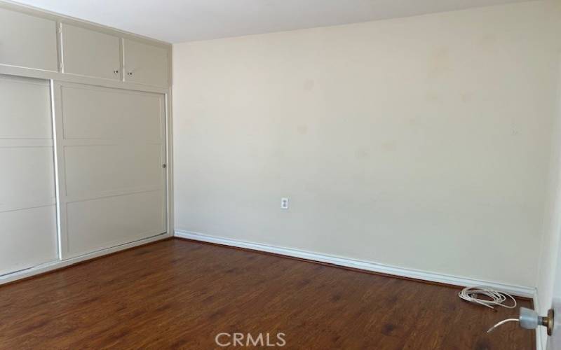 Guest bedroom as lots of closet space and storage cabinets.