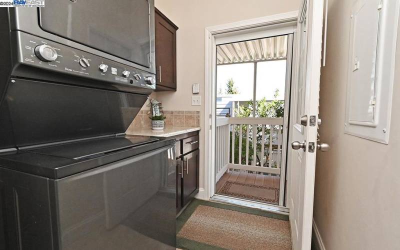 stackable washer dryer in laundryroom w/storage