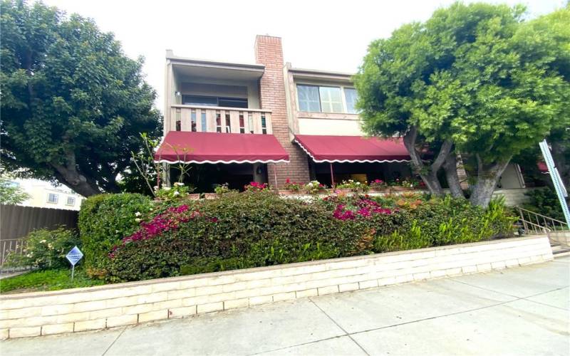 End Corner Unit with 2 awnings over large patio 
