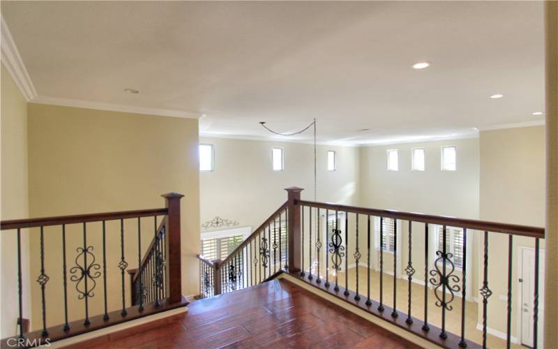 Landing of staircase overlooking the formal living/dining room/entryway.