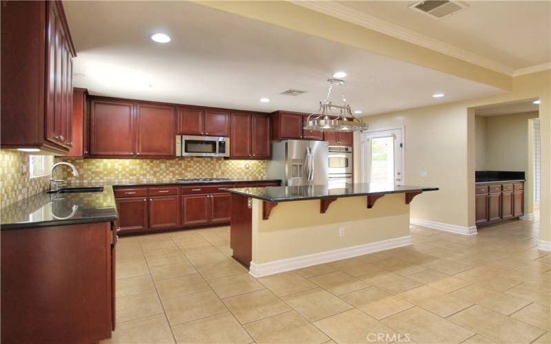 Kitchen with butlers pantry leading back into formal dining/living room.