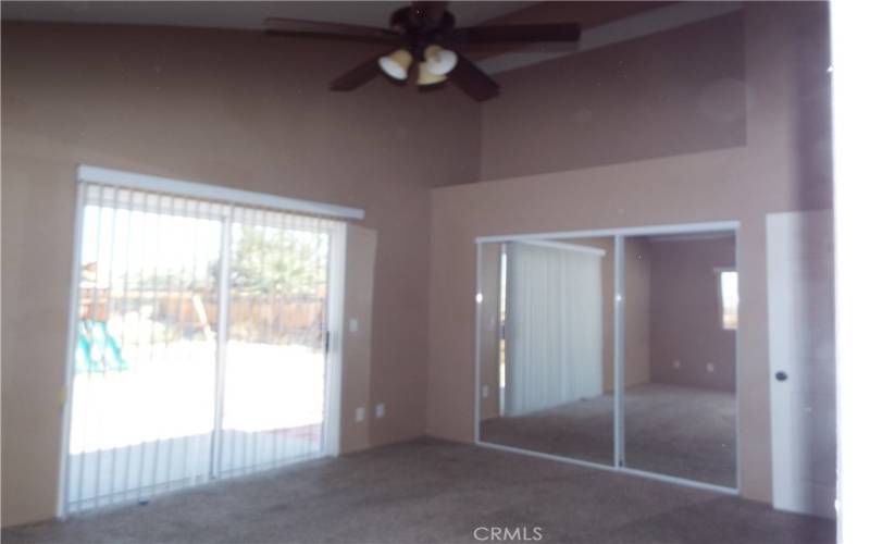 Primary Bedroom with Sliding Door Leading to Backyard, Mirrored closet & Bathroom