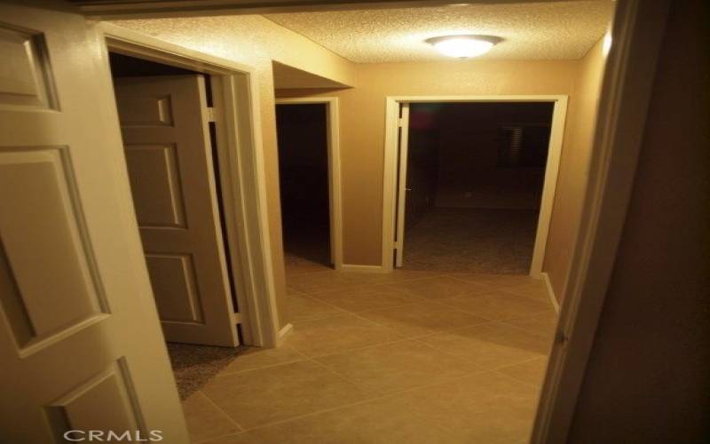 Hallway leads to 3 bedrooms