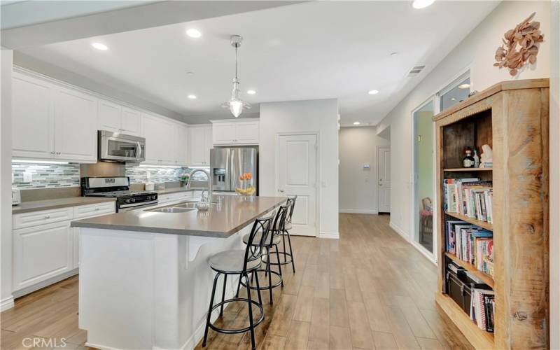 Kitchen with island breakfast bar, custom cabinetry and nautical pendant light