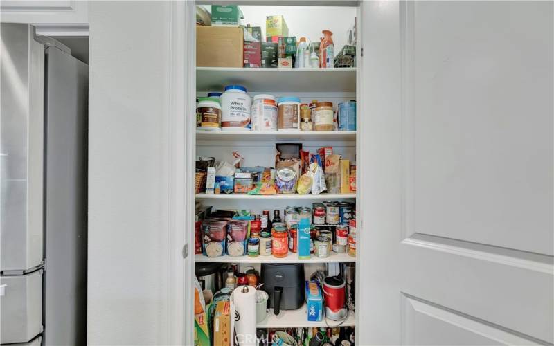  Wide pantry with built-in shelving for ample storage