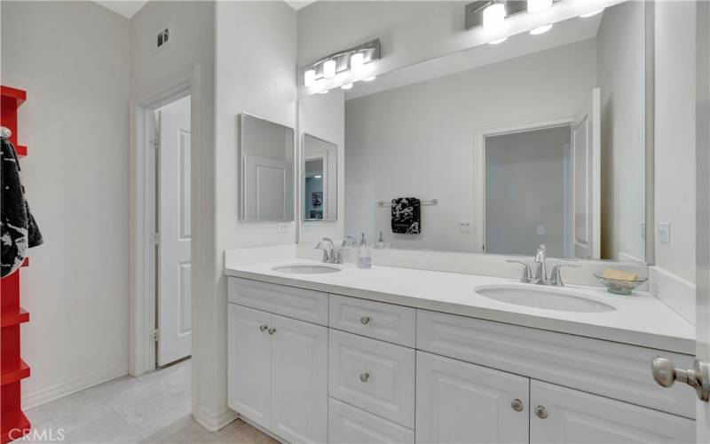 Second bathroom with a separate bathtub, dual vanity and separate toilet