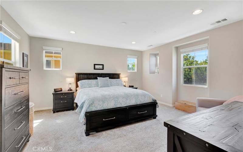 Primary bedroom w/ views of city lights and mountains