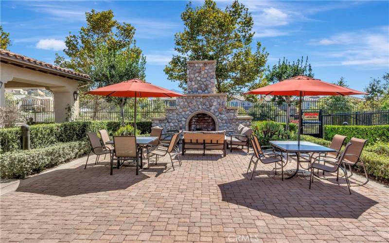 Alfresco dining area outside the clubhouse with fireplace