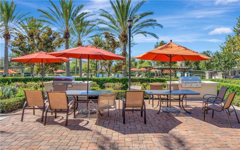 Outdoor dining space in community recreation center with BBQs