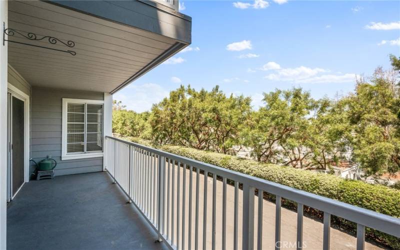 Spacious balcony with harbor and tree views