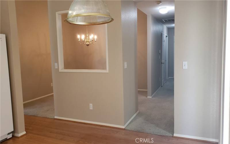 VIEW FROM KITCHEN TO DINING ROOM AND HALL LEADING TO LAUNDRY ROOM AMD BEDROOMS