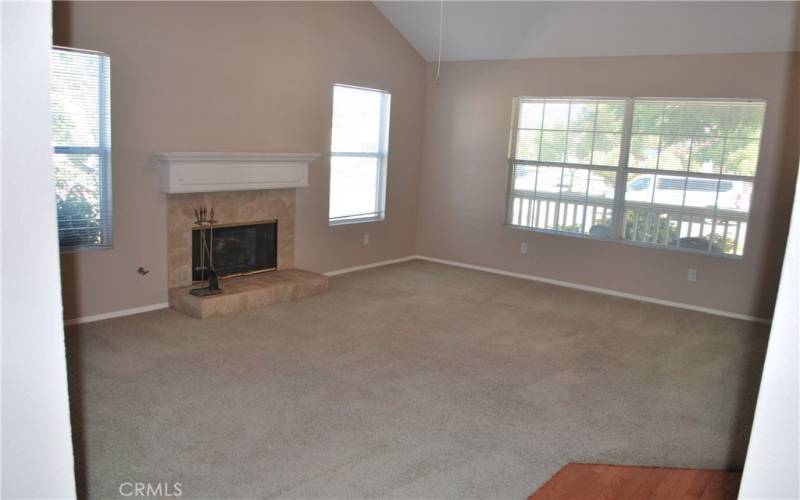 LIVING ROOM WITH FIREPLACE FACING FRONT PORCH.