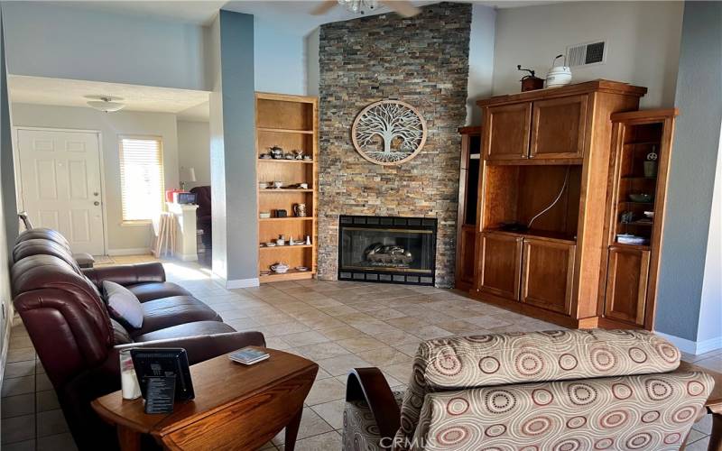 Cozy Family Room with Stone Accent Wall Next to Kitchen