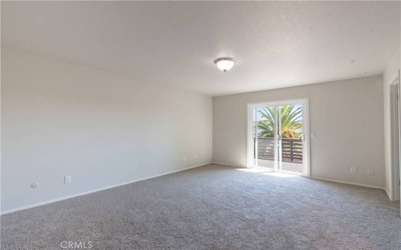 Primary bedroom with slider leading to deck