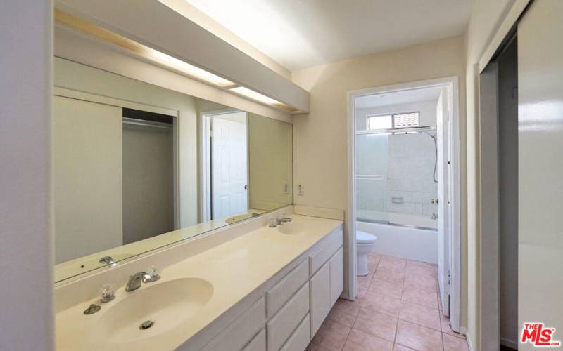 dual sinks and separate bathroom