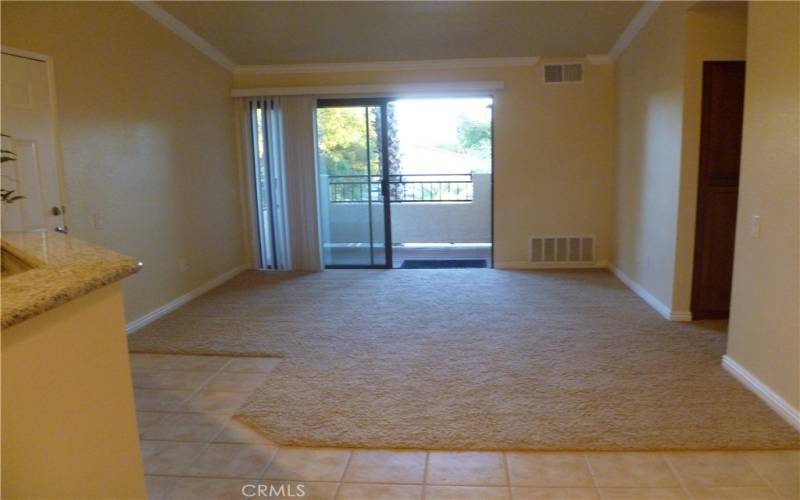 Spacious living room with vaulted ceiling and a patio deck.