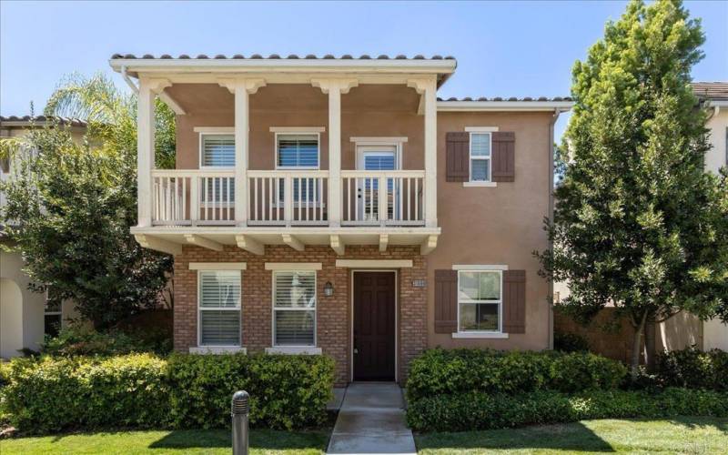 Charming brick facade entry under a romantic balcony gives this home a New Orleans feeling.